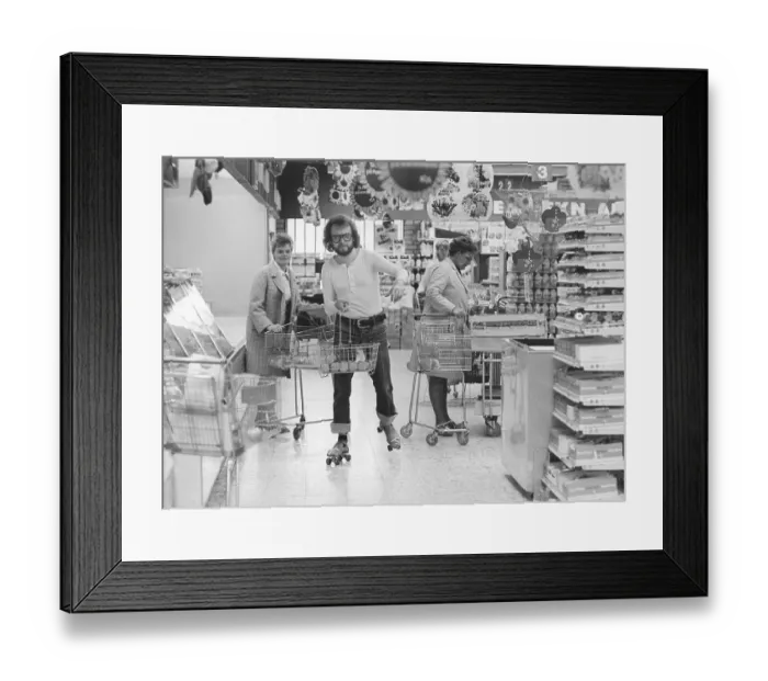 Framed Print : Roller skates 1972. A man on roller skates is seen in a grocery store, shopping along with two ladies. Sweden 1972