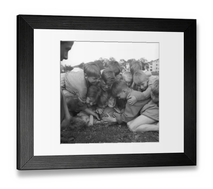Framed Print : Rugby 1940. A group of young rugby players all on top of one smiling boy who holds on to the rugby ball