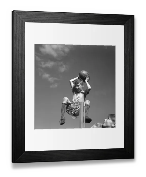 Framed Print : Rugby 1940. A young rugby player is holding the rugby ball in his hands