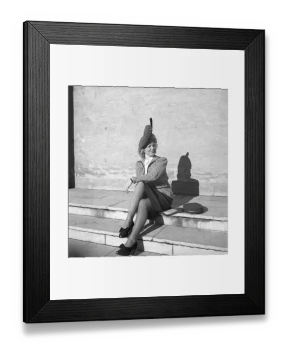 Framed Print : Women's fashion in the 1940s. A young woman dressed in a plaid patterned jacket and skirt