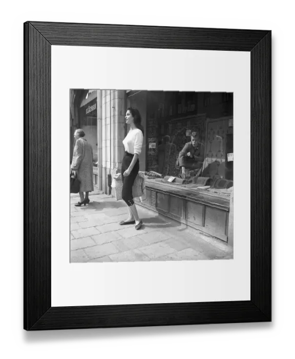 Framed Print : Young woman in 1956. She is standing in front of a shop window on Strandvaegen in Stockholm and maybe she is not aware of the guy in the carpet shop who is sitting inside the window and looking at her admiringly Framed Print : Young woman in 1956. She is standing in front of a shop window on Strandvaegen in Stockholm and maybe she is not aware of the guy in the carpet shop who is sitting inside the window and looking at her admiringly