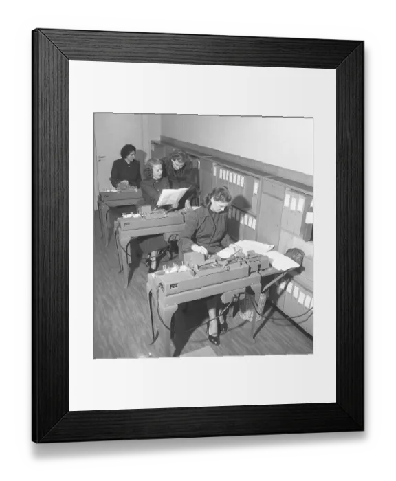 Framed Print : In the 1950s. Female clerks at punch card machines entering information that are transferred into punch cards Framed Print : In the 1950s. Female clerks at punch card machines entering information that are transferred into punch cards