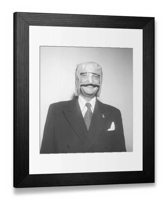Framed Print : In the 1950s. It is an odd headgear that the man in the suit wears on his head. The model is made of plastic with a transparent plastic material in front of the eyes Framed Print : In the 1950s. It is an odd headgear that the man in the suit wears on his head. The model is made of plastic with a transparent plastic material in front of the eyes