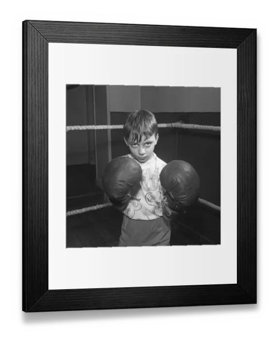 Framed Print : Young boxer in the 1950s. A boy wearing boxing gloves photographed in the boxing ring Framed Print : Young boxer in the 1950s. A boy wearing boxing gloves photographed in the boxing ring