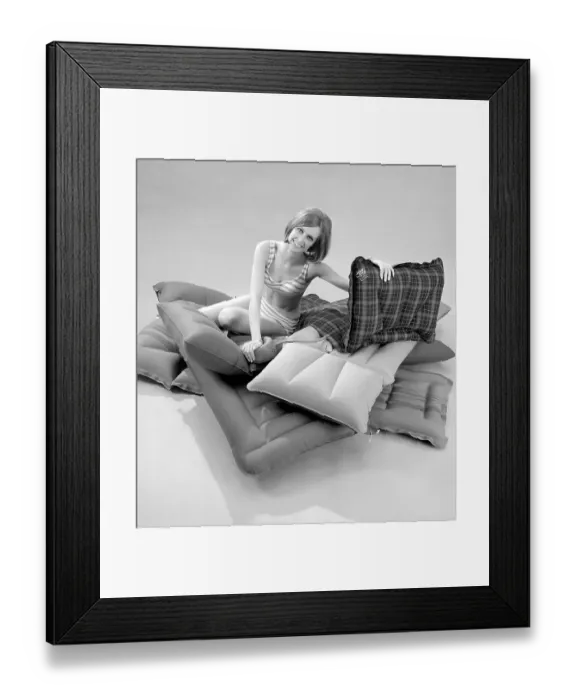 Framed Print : 1960s. A young woman wearing a bikini