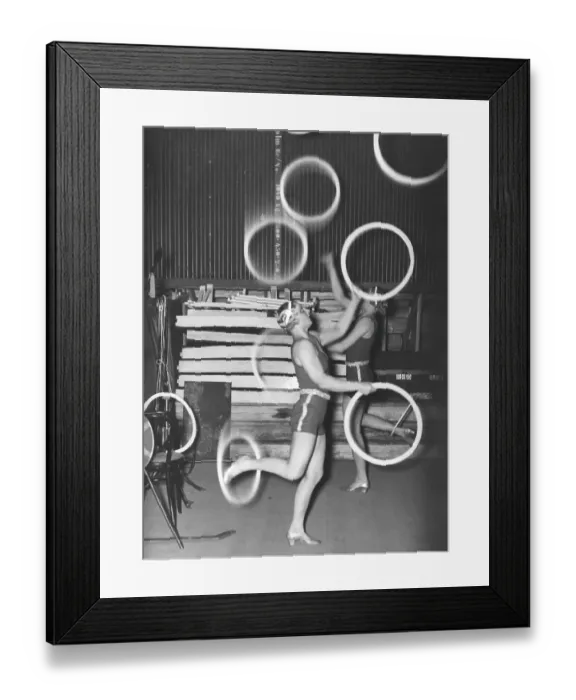 Framed Print : In the 1940s. Two women are seen juggling and balancing rings at the same time while standing on one leg only. Sweden 1946 Kristoffersson ref T68-4