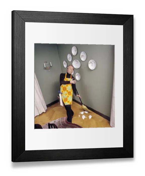 Framed Print : Cleaning day in the 1970s. An interior of a man cleaning the floor