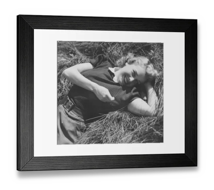 Framed Print : Actress in the 1940s. Swedish actress Agneta Lagerfelt pictured a summer day, lying in the grass looking into the camera. Sweden 1942 Kristoffersson