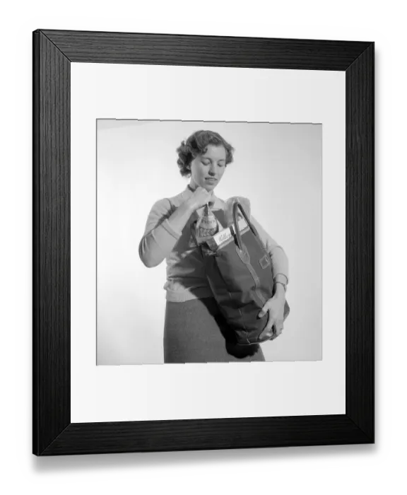 Framed Print : In the 1960s. A woman with her shopping bag. The classic Tetran milk package is visible. Invented by Ruben Rausings employee Erik Wallenberg in a tetrahedron form, that became the start of the Tetra Pak packaging empire. Sweden 1960. Conard ref 4188