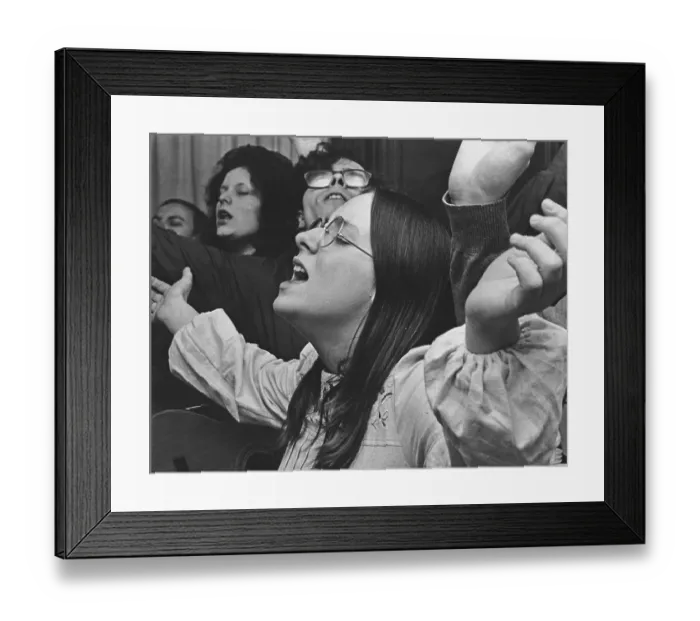 Framed Print : Revival meeting. Participants in a free church meeting sing and pray together visibly focused and in the moment