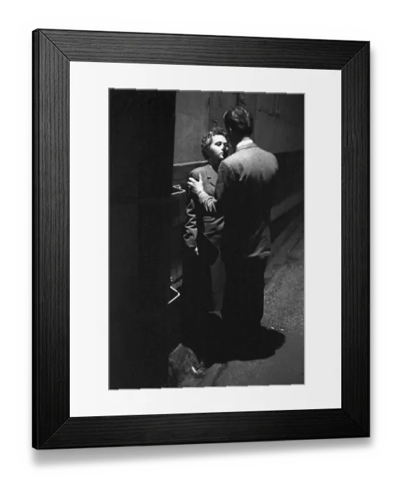 Framed Print : In the 1950s. A young couple in the evening standing close to each other Framed Print : In the 1950s. A young couple in the evening standing close to each other