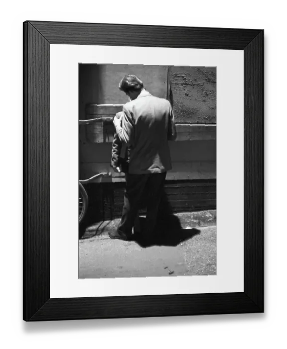 Framed Print : In the 1950s. A young couple in the evening standing close to each other