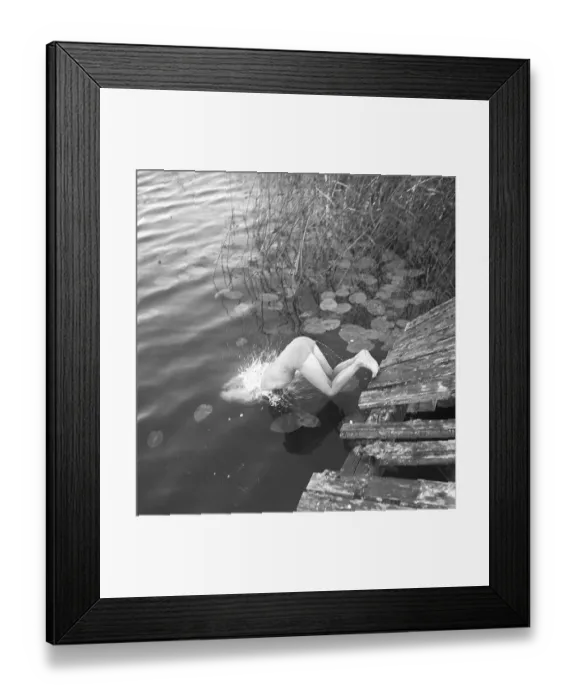 Framed Print : 1940s summer. A young girl is pictured in the moment when she dives into the water Framed Print : 1940s summer. A young girl is pictured in the moment when she dives into the water