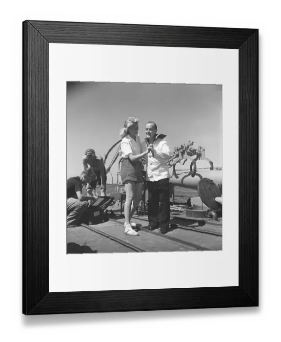 Framed Print : Ake Soederblom, 1910-1965, Swedish actor here during the filming of a feature film on a Swedish warship. He is dressed in a sailor's uniform and is seen dancing with a young blonde woman on the ship's deck during a break in filming