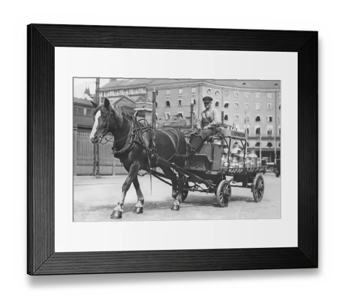 Framed Print : In the 1930s. A horse and carriage pictures in a Stockholm street 1936. The horse-drawn cart has a load of large milk bottles