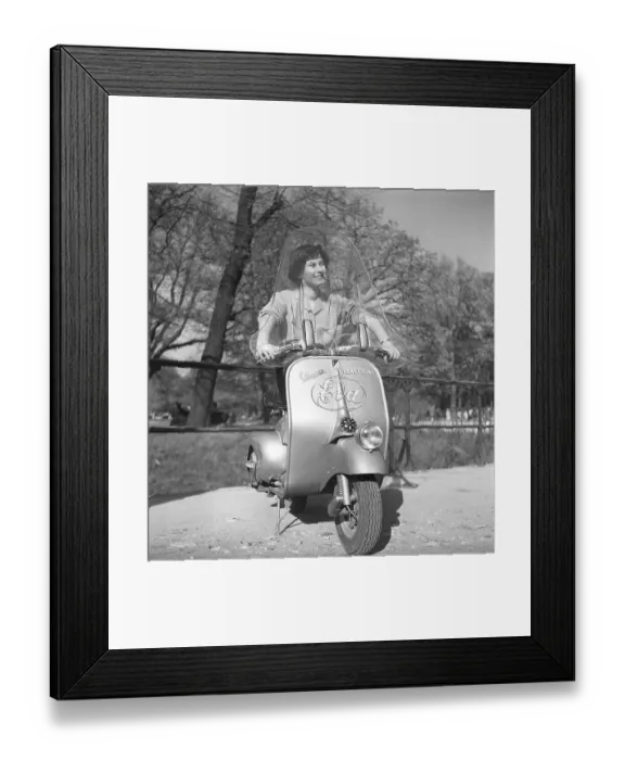 Framed Print : Driving in Italy in the 1950s. A young woman on a Vespa scooter in Milan Italy 1950