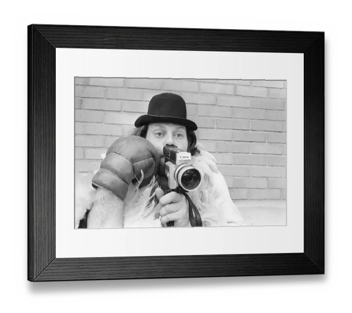 Framed Print : In the 1970s. A man is filming with a amateur film camera Framed Print : In the 1970s. A man is filming with a amateur film camera