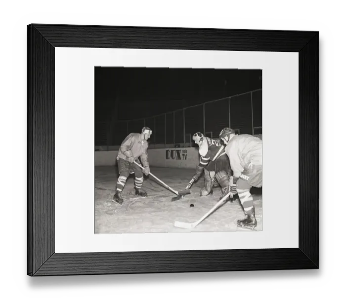 Framed Print : Ice hockey in the 1950s. A goalkeeper and two players on the ice hockey rink Framed Print : Ice hockey in the 1950s. A goalkeeper and two players on the ice hockey rink
