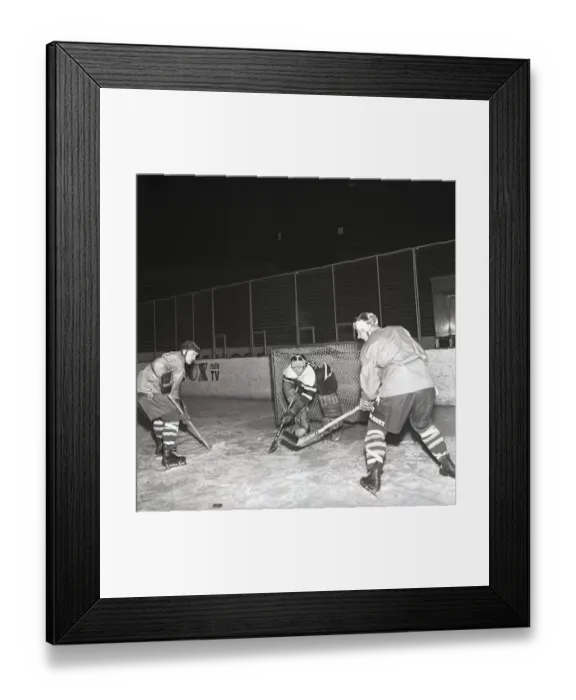 Framed Print : Ice hockey in the 1950s. A goalkeeper and two players on the ice hockey rink