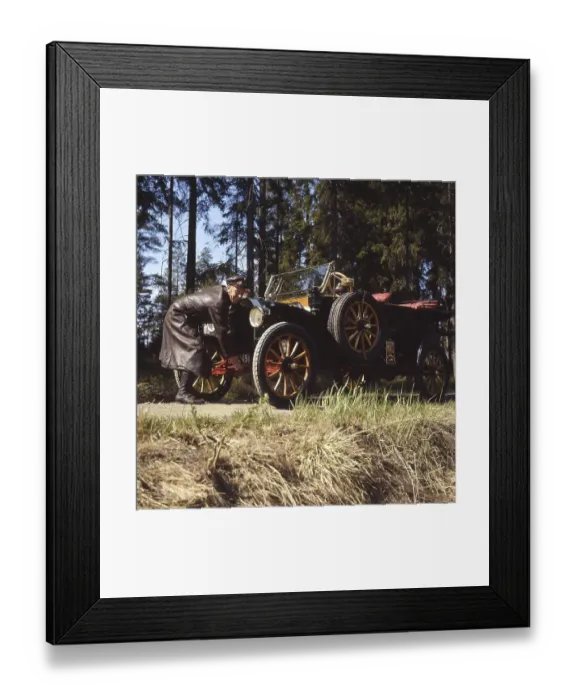 Framed Print : The old car. A man in a typical old fashioned driver's outfit complete with a leather cap Framed Print : The old car. A man in a typical old fashioned driver's outfit complete with a leather cap