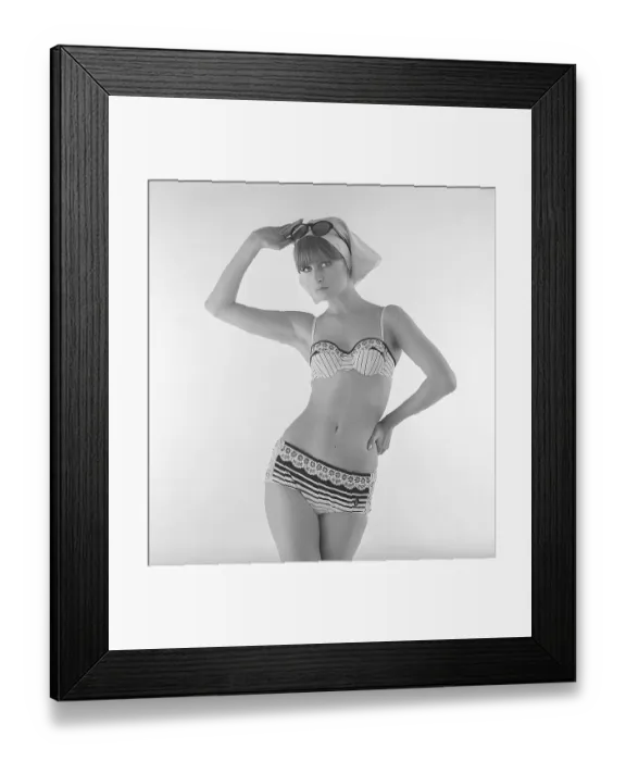 Framed Print : Woman in the 1960s. A fashion model shows bikini fashion. The model has a bottom with a striped pattern and printed lace and a matching top with thin stripes and printed lace with a highlighted border. 1966. Kristoffersson ref DO41-2 Framed Print : Woman in the 1960s. A fashion model shows bikini fashion. The model has a bottom with a striped pattern and printed lace and a matching top with thin stripes and printed lace with a highlighted border. 1966. Kristoffersson ref DO41-2