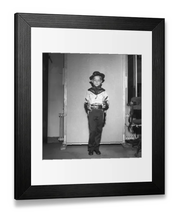 Framed Print : Boy in the 1950s. A boy is dressed in cowboy clothes