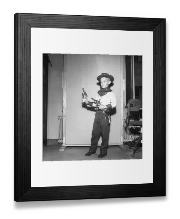 Framed Print : Boy in the 1950s. A boy is dressed in cowboy clothes, shirt, gun holster and cowboy hat and holds two toy revolvers. 1950. Kristoffersson ref AZ47-10 Framed Print : Boy in the 1950s. A boy is dressed in cowboy clothes, shirt, gun holster and cowboy hat and holds two toy revolvers. 1950. Kristoffersson ref AZ47-10