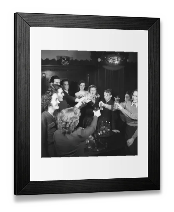 Framed Print : In the 1940s. A non-alcohol toast with young people raising their glasses in celebration with just soda in them Framed Print : In the 1940s. A non-alcohol toast with young people raising their glasses in celebration with just soda in them