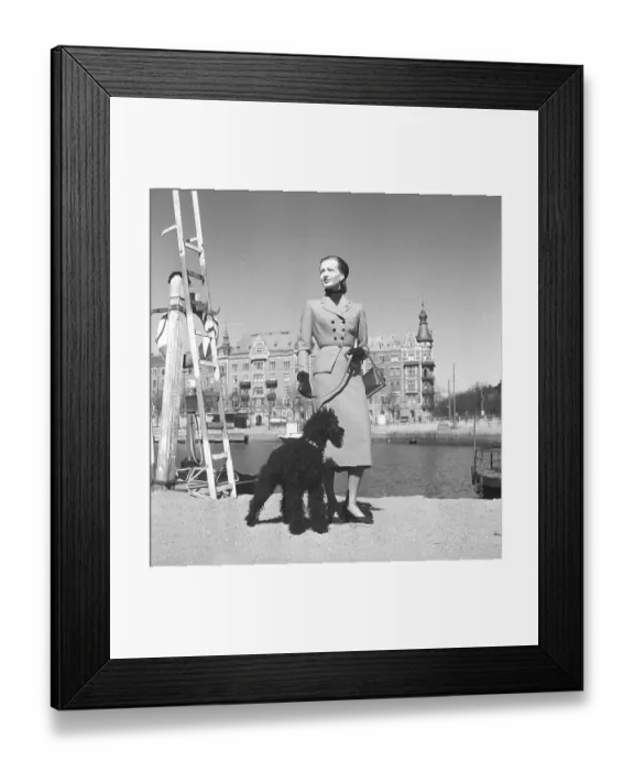 Framed Print : Fashionable in the 1950s. A young woman is wearing a typical 1950s coat Framed Print : Fashionable in the 1950s. A young woman is wearing a typical 1950s coat