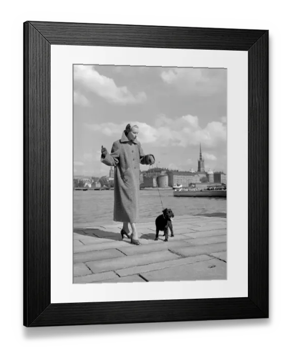 Framed Print : Fashionable in the 1950s. A young woman wears a typical 1950s coat