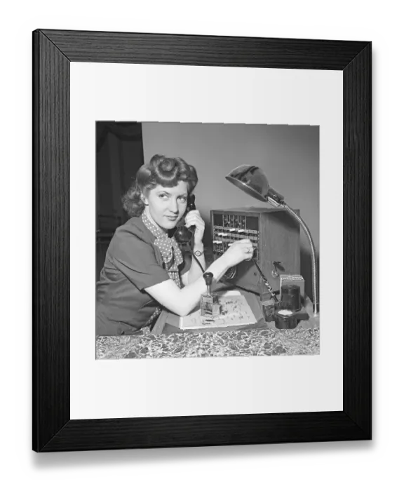Framed Print : A young movie star-like woman works in the company's switchboard