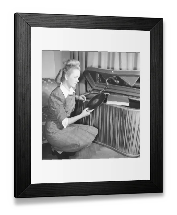 Framed Print : Woman at a gramophone in the 1940s