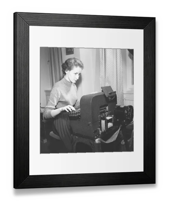 Framed Print : In the 1950s. Single female clerk at punch card machine entering information into punch cards