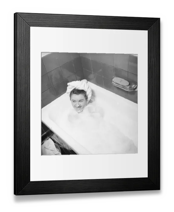 Framed Print : In the bathtub in the 1940s. A young woman lies in the bathtub. She is covered in bath foam and has a towel on her head. Playfully, she also has bath foam on her nose and laughs. Sweden 1947. Kristoffersson ref AB3-1 Framed Print : In the bathtub in the 1940s. A young woman lies in the bathtub. She is covered in bath foam and has a towel on her head. Playfully, she also has bath foam on her nose and laughs. Sweden 1947. Kristoffersson ref AB3-1