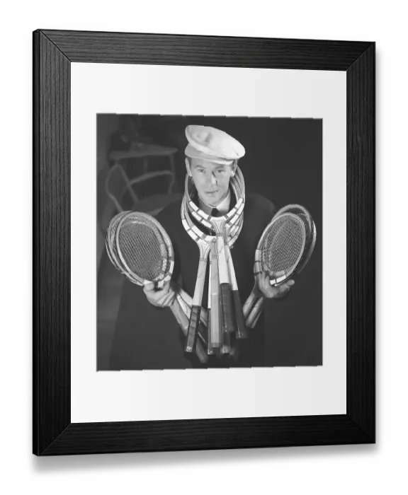 Framed Print : In the 1940s. A young man in a cap stands and holds the tennis racket in his hands Framed Print : In the 1940s. A young man in a cap stands and holds the tennis racket in his hands