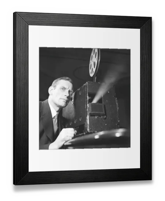 Framed Print : Man at a film projector in the 1940s Framed Print : Man at a film projector in the 1940s