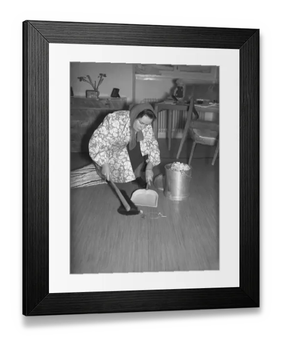 Framed Print : The young Uppsala student Eva-Britt Ohlsson cleans and sweeps the floor from dust and dirt on a February day in 1940