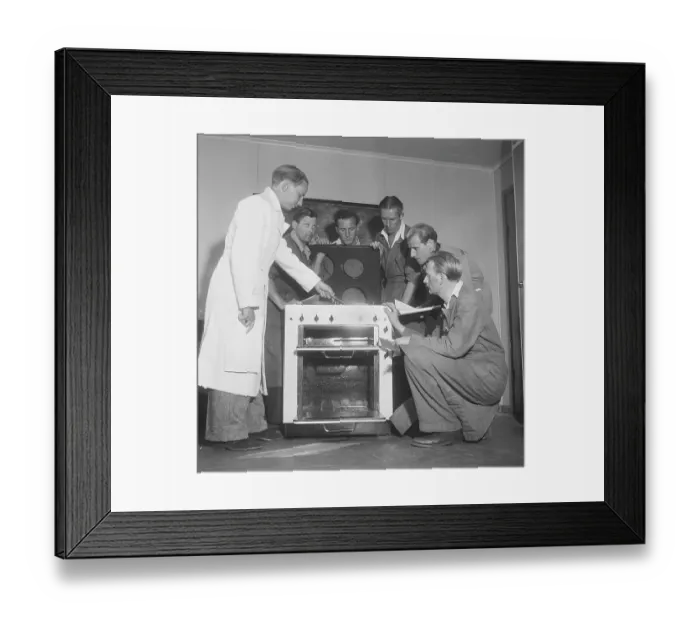 Framed Print : In the 1950s. A man at an electric cooker from swedish manufacturer Husqvarna