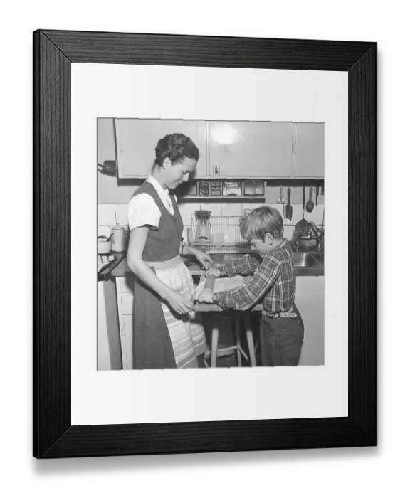 Framed Print : Baking in the 1950s. A mother with her son in the kitchen Framed Print : Baking in the 1950s. A mother with her son in the kitchen