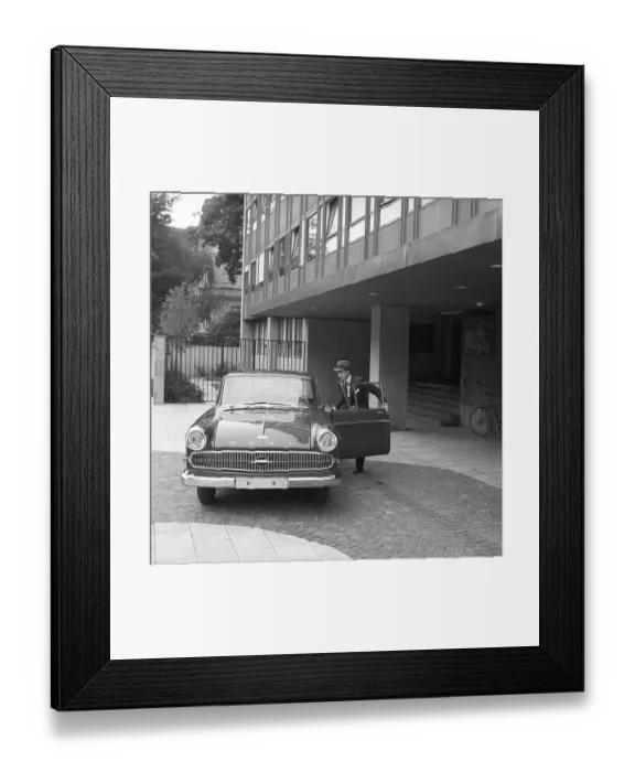 Framed Print : In the 1960s. A man is seen standing at his car Framed Print : In the 1960s. A man is seen standing at his car