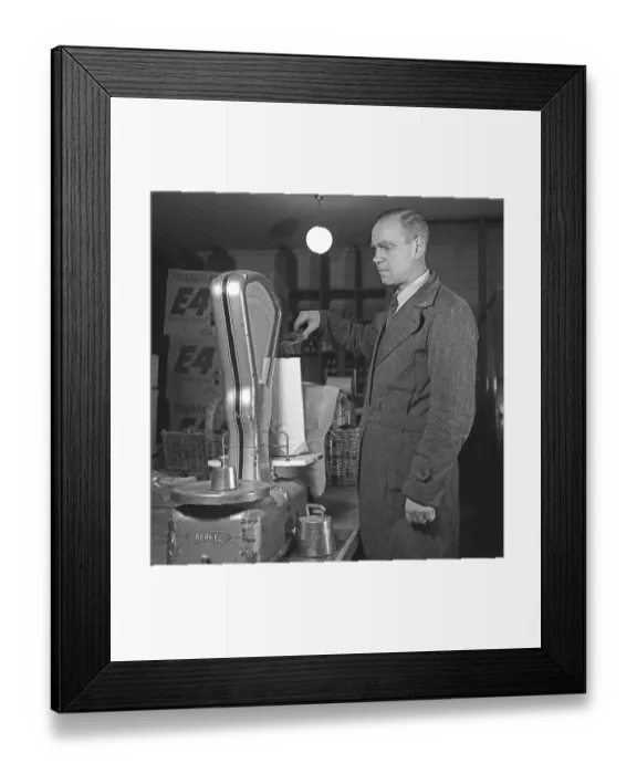 Framed Print : Shop scale in the olden days. A man measures an item in a bag on a scale at the company Arvid Nordquist in Stockholm Framed Print : Shop scale in the olden days. A man measures an item in a bag on a scale at the company Arvid Nordquist in Stockholm