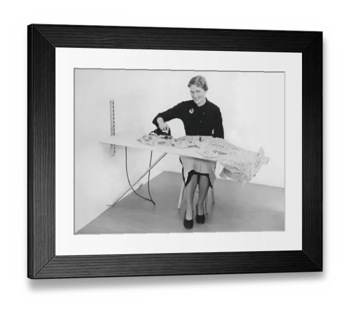 Framed Print : Ironing in the 1950s. A woman seen ironing her clothes. Sweden 1955