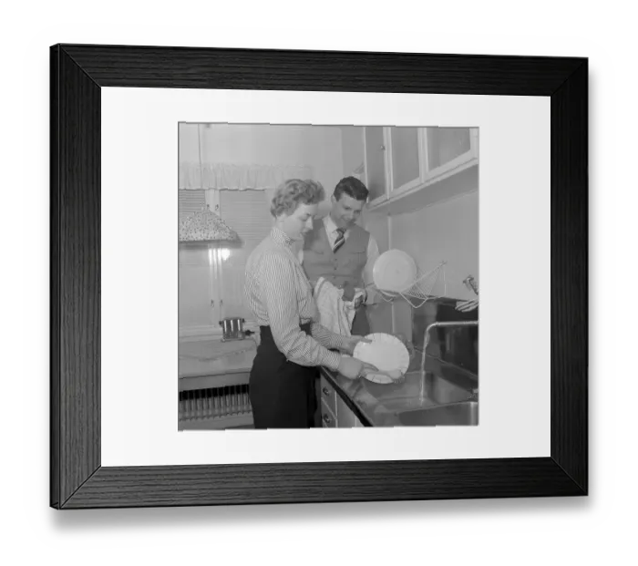 Framed Print : In the kitchen 1950s. A young couple is doing the dishes in the kitchen, she cleans the plates and he dries them with a towel. He is singer Cacka Israelsson, 1929-2013. Sweden 1954. Conard ref 2643 Framed Print : In the kitchen 1950s. A young couple is doing the dishes in the kitchen, she cleans the plates and he dries them with a towel. He is singer Cacka Israelsson, 1929-2013. Sweden 1954. Conard ref 2643