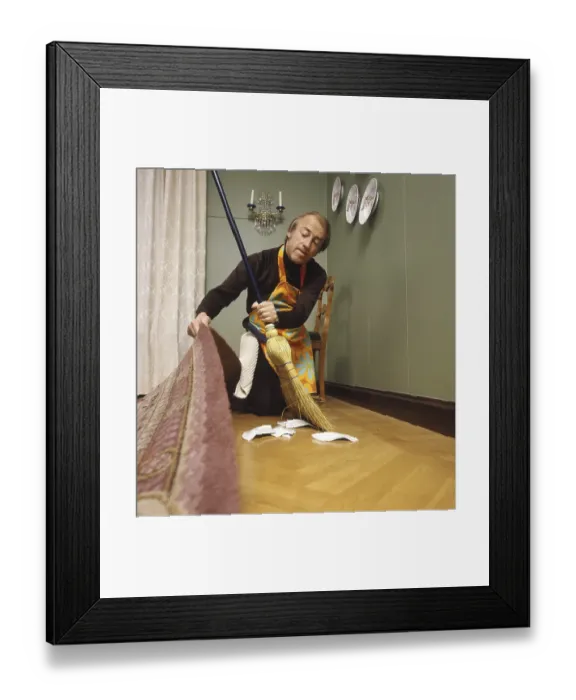 Framed Print : Cleaning day in the 1970s. An interior of a man cleaning the floor Framed Print : Cleaning day in the 1970s. An interior of a man cleaning the floor