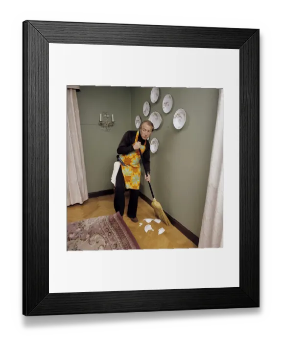 Framed Print : Cleaning day in the 1970s. An interior of a man cleaning the floor Framed Print : Cleaning day in the 1970s. An interior of a man cleaning the floor