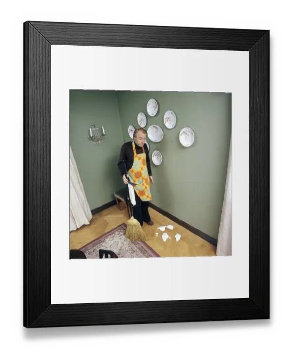 Framed Print : Cleaning day in the 1970s. An interior of a man cleaning the floor Framed Print : Cleaning day in the 1970s. An interior of a man cleaning the floor