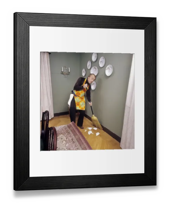 Framed Print : Cleaning day in the 1970s. An interior of a man cleaning the floor