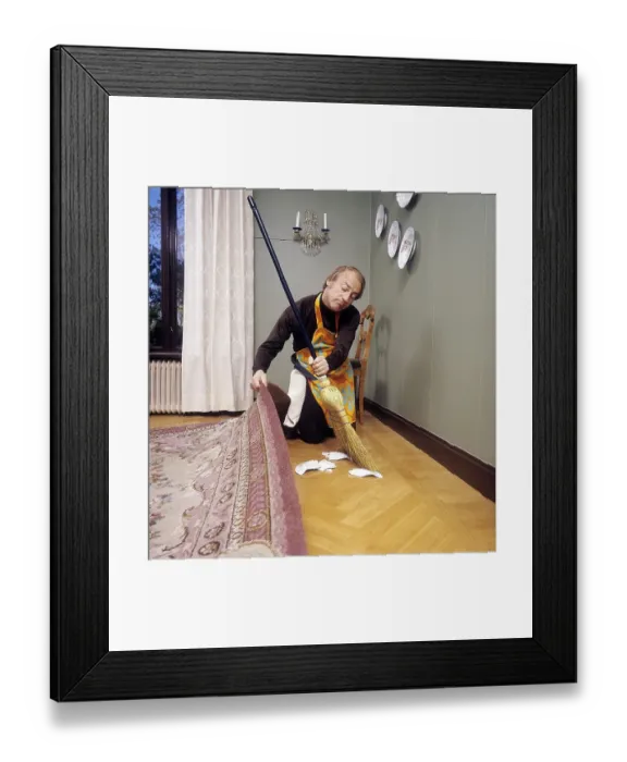 Framed Print : Cleaning day in the 1970s. An interior of a man cleaning the floor Framed Print : Cleaning day in the 1970s. An interior of a man cleaning the floor