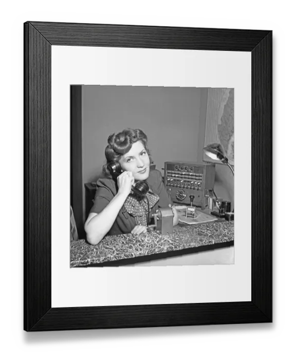 Framed Print : A young movie star-like woman works in the company's switchboard