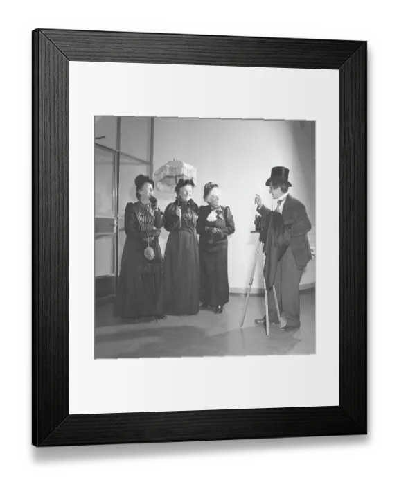 Framed Print : Three elderly women dressed in dresses from the turn of the century pose in front of a photographer with a camera Framed Print : Three elderly women dressed in dresses from the turn of the century pose in front of a photographer with a camera
